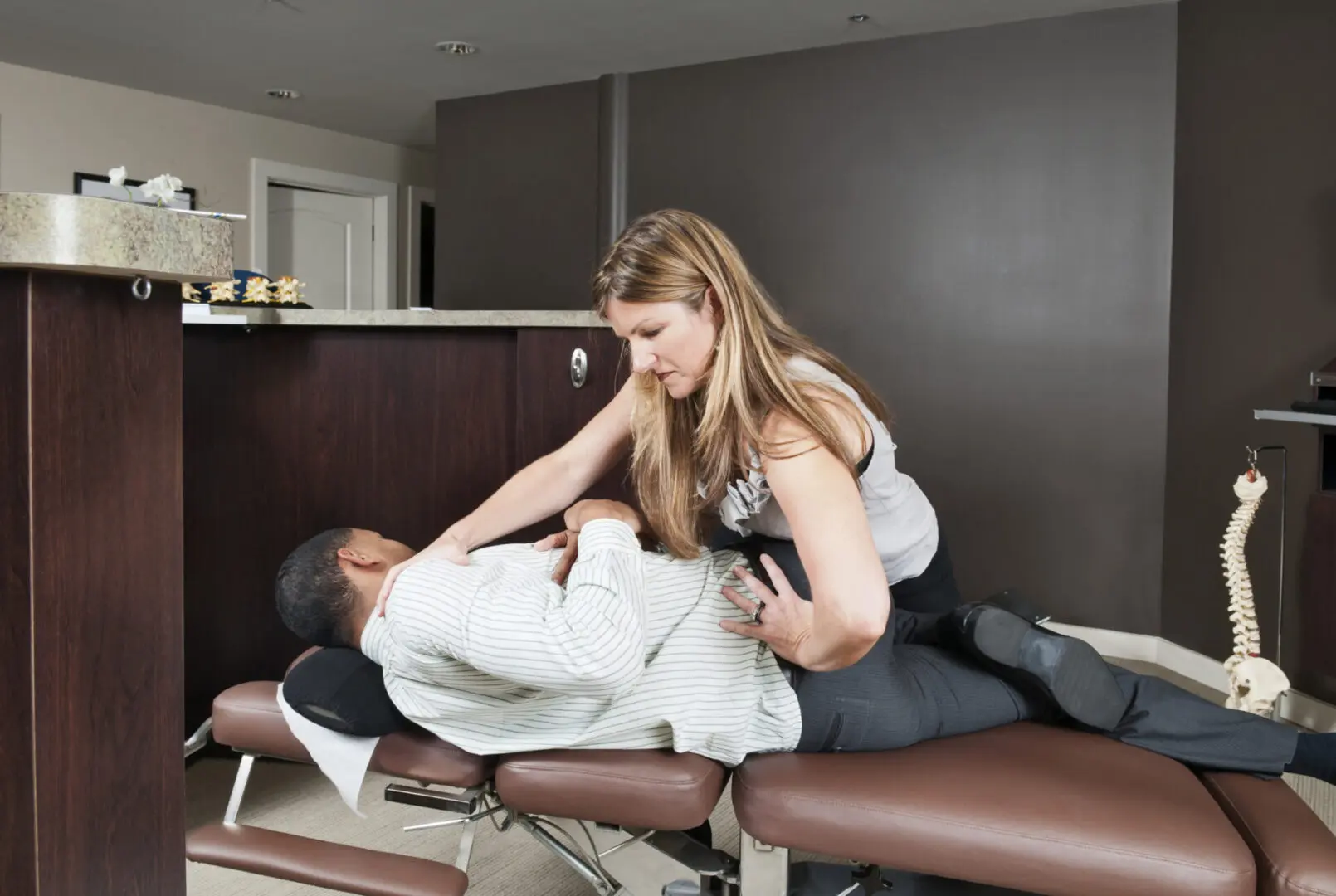 Chiropractor performing adjustment on a patient.