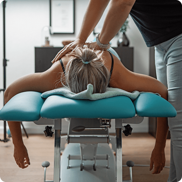 Person receiving a back massage on table.